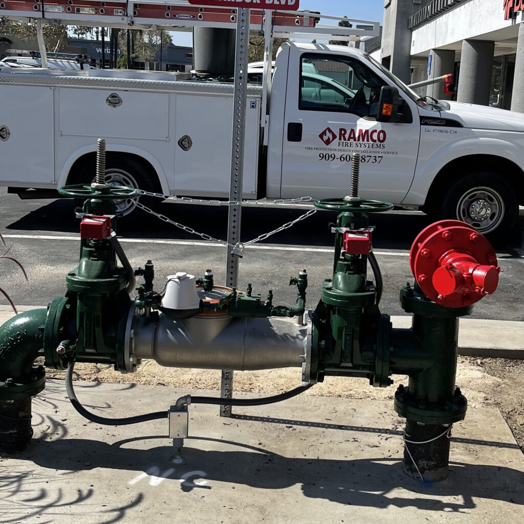 Picture of white and red Ramco Fire Systems truck in front of green and red fire hydrant